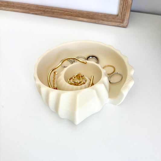 Ammonite Tray 3D printed styled with rings, bracelets and necklaces on a white surface