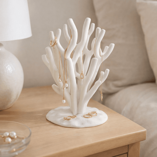 Coral jewellery stand styled on bedside table holding necklaces — modern home decor